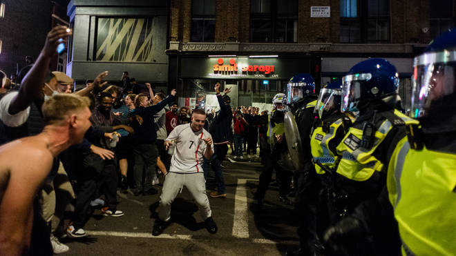Riot police faced off with England fans in central London.