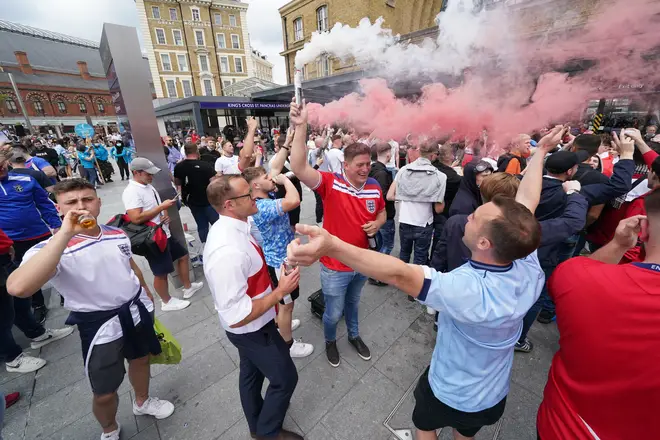 Supporters set off smoke flares and threw drinks as the party atmosphere grew.