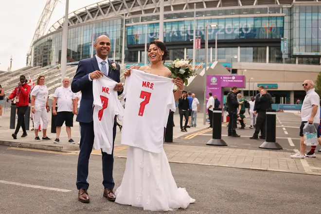 Newly married couple Amish (l) and Nimisha take wedding photos outside of Wembley Stadium.
