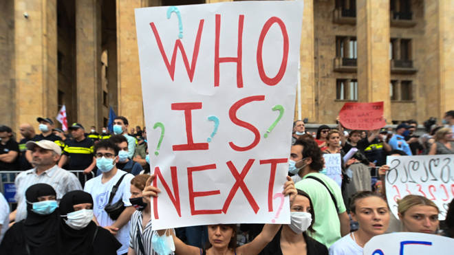 A woman holds up a placard during a rally in Tbilisi on Sunday