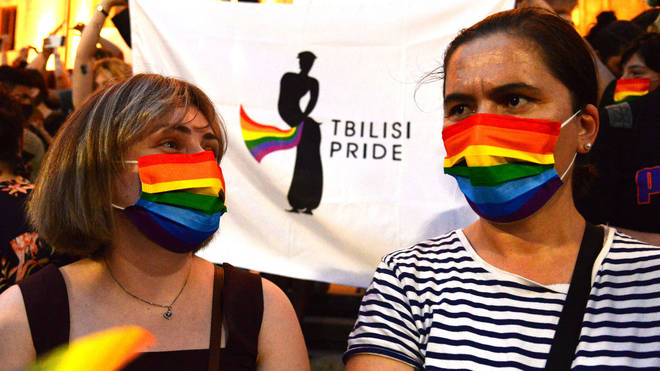 Participants wear rainbow protective masks during an LGBTQ+ rally in Tbilisi