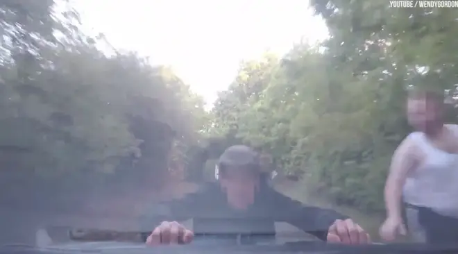 The moment a fly-tipper clung to the car bonnet