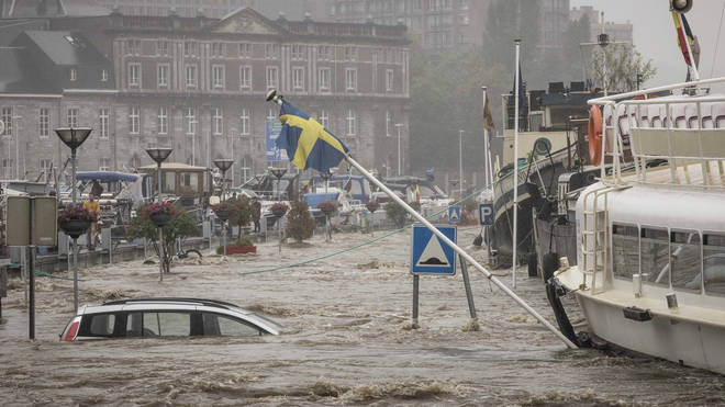 Cars have been submerged in the heavy flooding in Liege, Belgium.