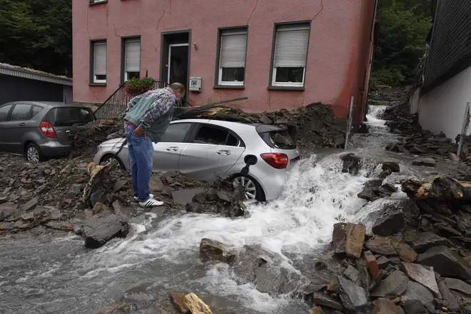 A resident looks at the damage caused by the flooding of the Nahma in Hagen, North Rhine-Westphalia. Heavy rain turned the small river into a raging torrent.