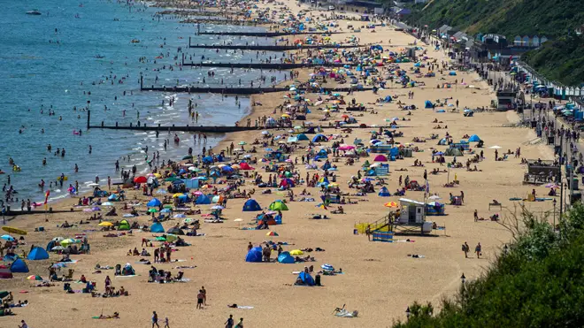 People enjoy the weather on Bournemouth beach in Dorset yesterday