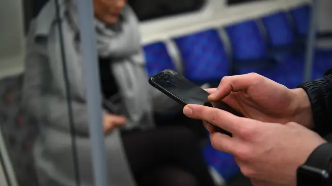 A person with a phone on public transport