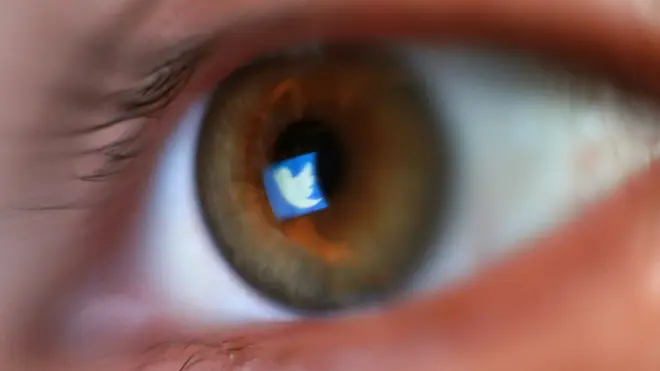 The Twitter logo reflected in an eye