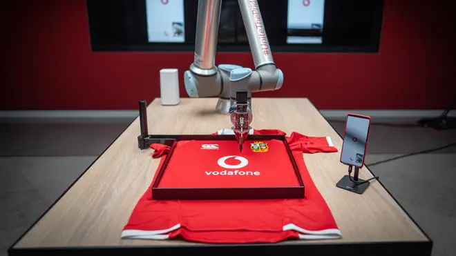 British & Irish Lions located in South Africa sign shirts of fans back in London, using 5G robotic arm
