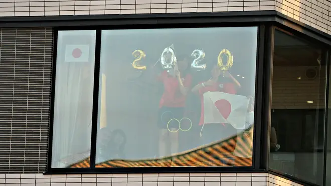 Residents of the adjacent apartment block tried to catch a glimpse of the ceremony