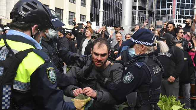 A protester is arrested by police