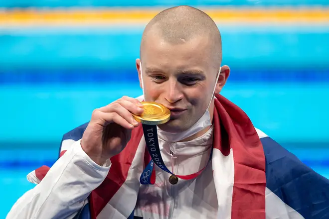 Adam Peaty of Great Britain shows the gold medal after winning the men 100m Breaststroke final during the Tokyo 2020 Olympic Games