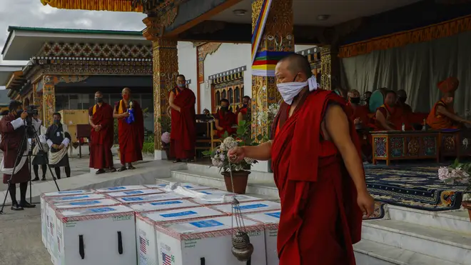 This photograph provided by UNICEF shows monks from Paro’s monastic body perform a ritual as 500,000 doses of Moderna COVID-19 vaccine gifted from the United States arrived at Paro International Airport in Bhutan