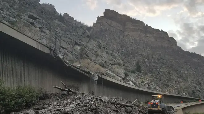 Equipment works to clear mud and debris from a mudslide on Interstate-70 through Glenwood Canyon, Colorado