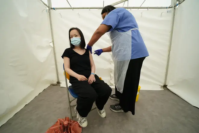 A person receives a jab during a four-day vaccine festival in Langdon Park, Poplar