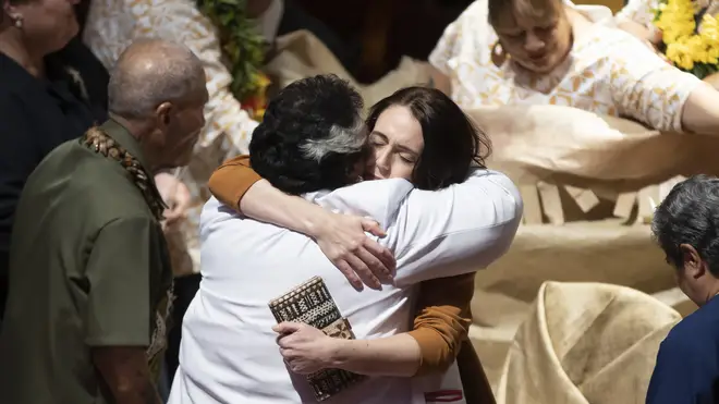 Jacinda Ardern is hugged during a ceremony in Auckland