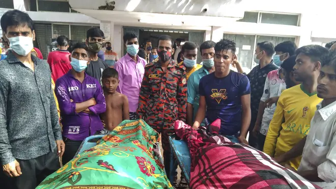 People gather around bodies of victims after lightning killed more than a dozen people in Bangladesh