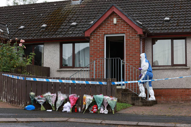 Forensics officers at the scene in Dungannon, Co Tyrone, where a two-year-old who was found injured on Friday afternoon was rushed to hospital and later died.