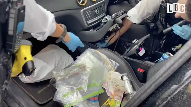 Police reveal the hidden cache of drugs and money in the car