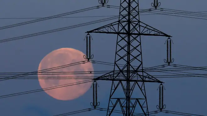 A 'blue moon' behind an electricity pylon