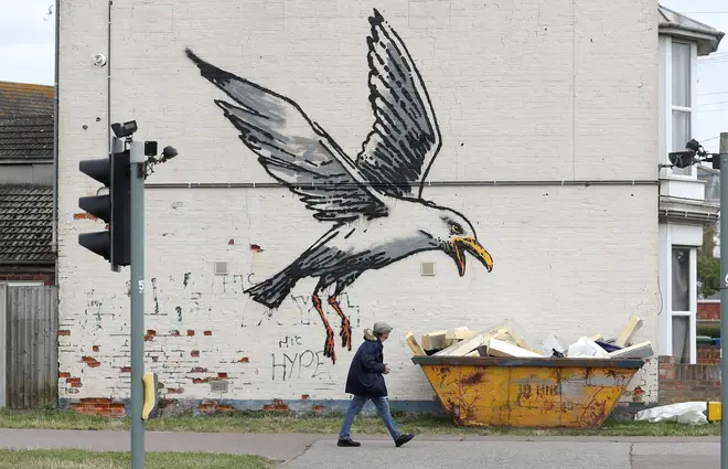 Painted on the corner of Denmark Road and Katwijk Way, Lowestoft, opposite the railway station, depicts a large seagull hovering above a skip filled with pieces of wood which are made to resemble chips.