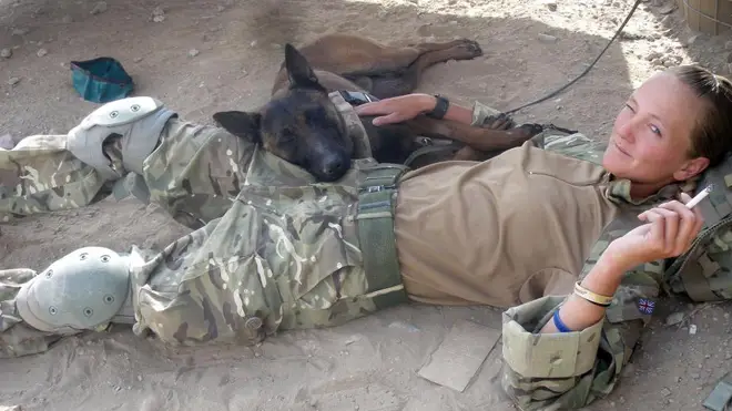 The Army dog relaxing with a soldier in Afghanistana