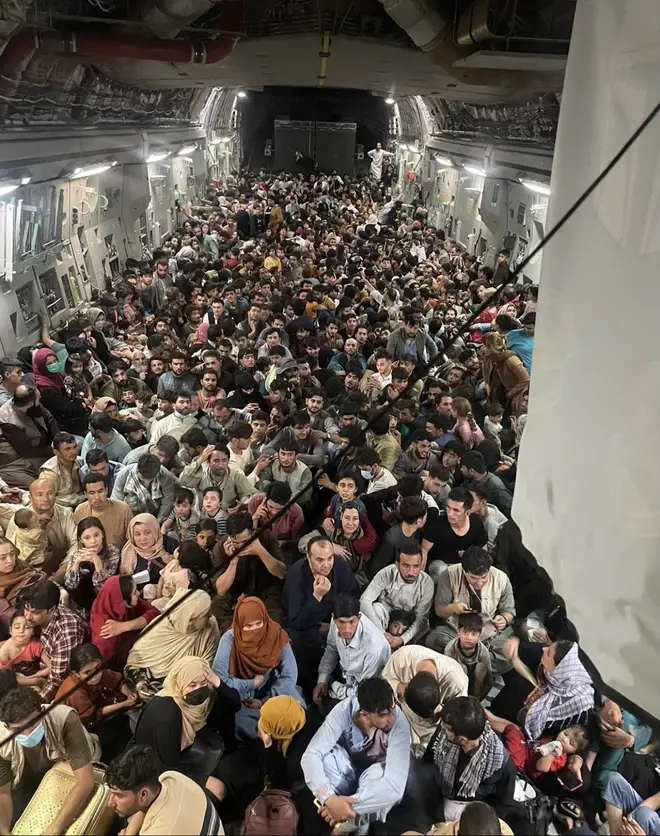A photograph showed hundreds of Afghan refugees crammed into an "unplanned" rescue flight