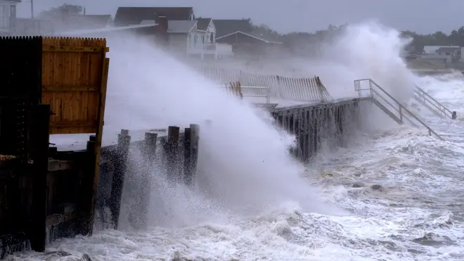 Waves pound a seawall in Montauk, New York as Tropical Storm Henri affects the Atlantic coast