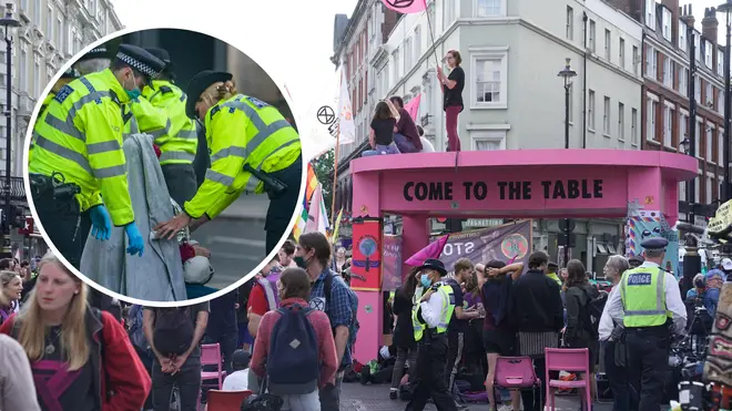 A giant pink table erected by XR protesters in central London has been dismantled by police