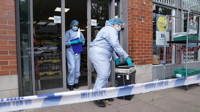 Forensics officers at one of the supermarkets yesterday