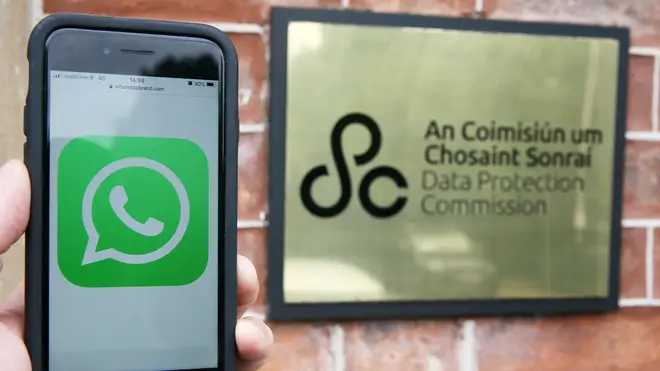 An iPhone displaying a WhatsApp logo