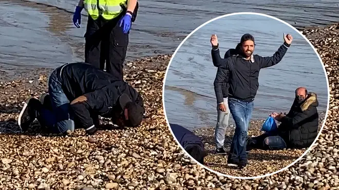 The group of migrants were seen kissing the beach and praying on the pebbles at Dungeness in Kent.
