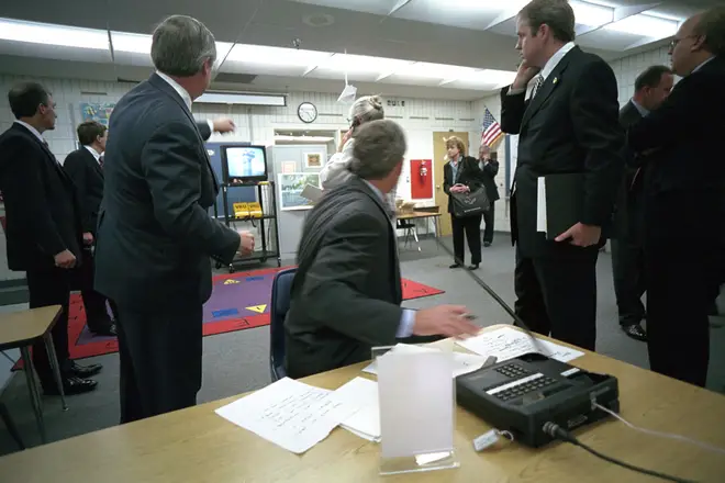 President Bush (centre) and his advisers watch television coverage of the attacks from a classroom at the school in Florida