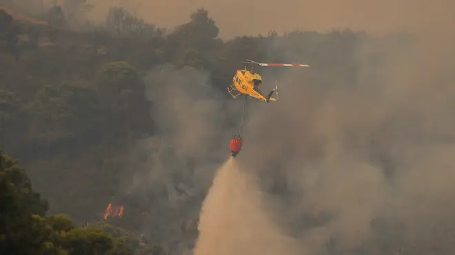 Helicopters have been making water drops in an attempt to get the fire under control.