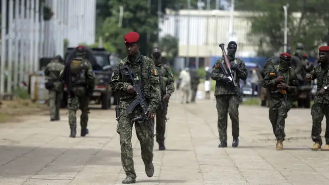 Guinean soldiers patrol outside the Presidential palace in Conakry, Guinea (Sunday Alamba/AP)