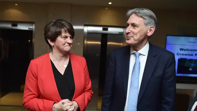 DUP leader Arlene Foster greets the UK Chancellor Philip Hammond as he arrives at the Democratic Unionist Party Conference
