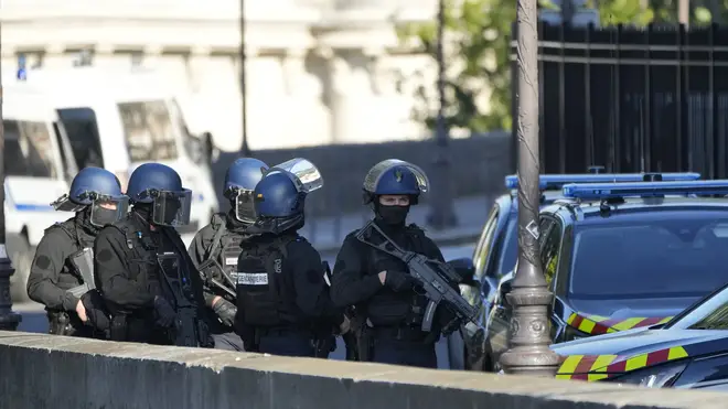 Security forces patrol outside at the Palais de Justice in Paris
