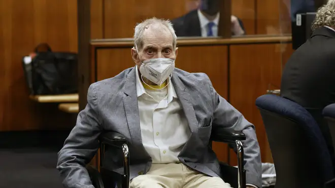 Robert Durst spins in place in his wheelchair as he looks at people in court