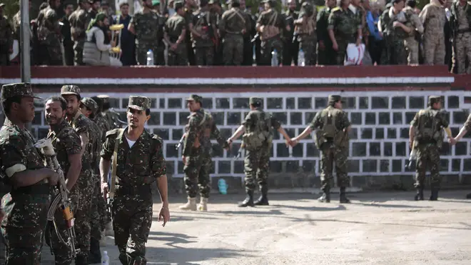 Soldiers stand guard during the execution of nine men (Hani Mohammed/AP)