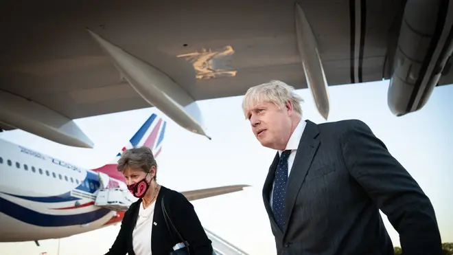 Boris Johnson, accompanied by Dame Barbara Janet Woodward walks across the tarmac of New York’s JFK airport