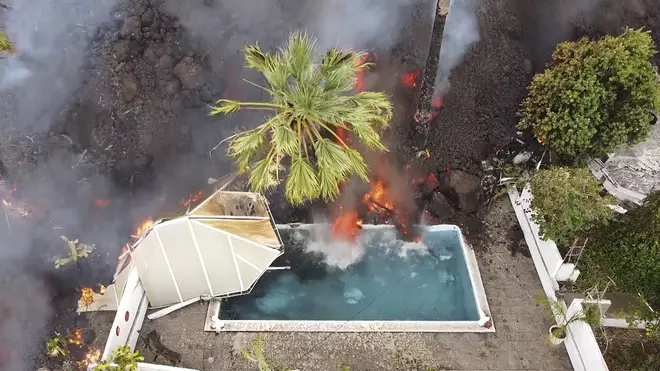 Hot lava reaches a swimming pool on the island of La Palma