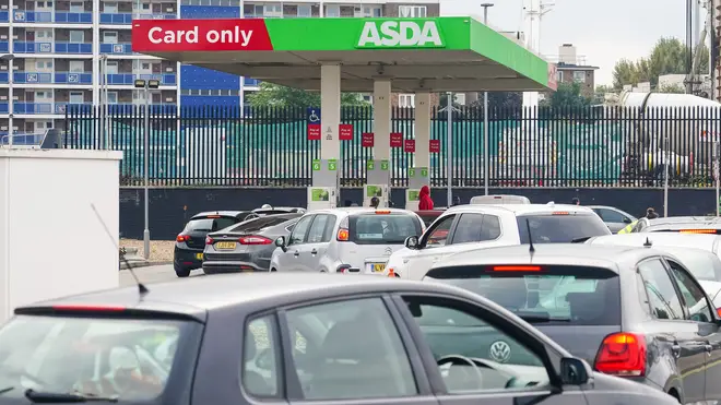 Cars queue for fuel at an Asda petrol station in south London amid continued panic buying