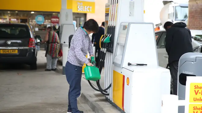 A motorist filling up a jerry can at a London petrol station on Monday