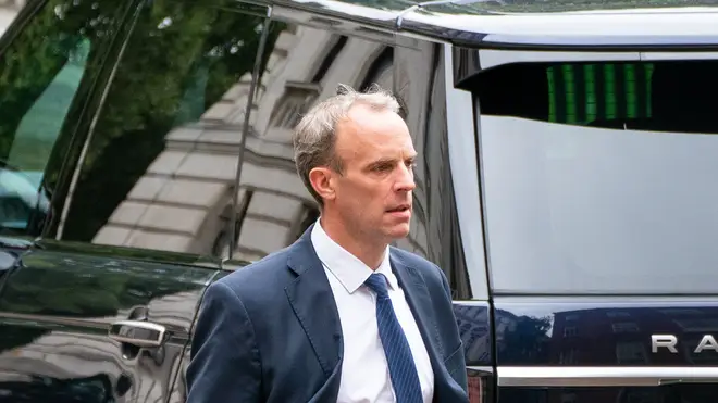 Dominic Raab walks to the rear entrance of Downing Street