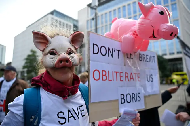 A pig farmer protests outside the Conservative Party conference on Monday
