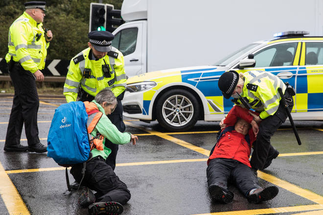 Insulate Britain protesters on an M25 slip road, near Heathrow Airport, on 27 September