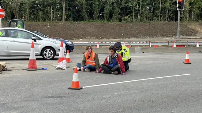 Two protesters glued themselves to the road in the protest near the M25