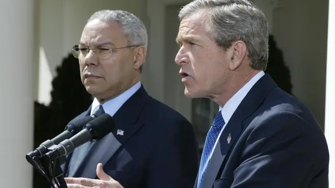 George W Bush pictured with Colin Powell in 2002
