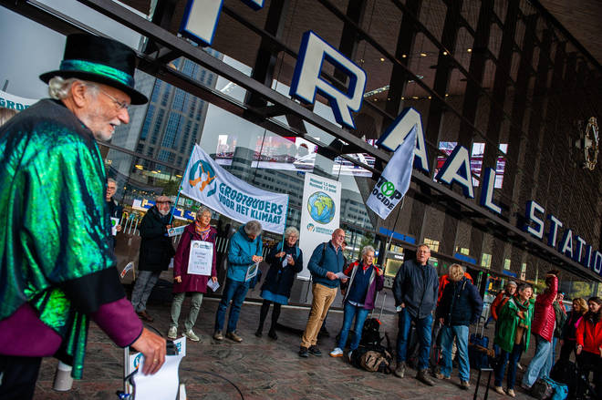 Climate protesters who will demonstrate in Glasgow gather in Rotterdam before heading to Scotland