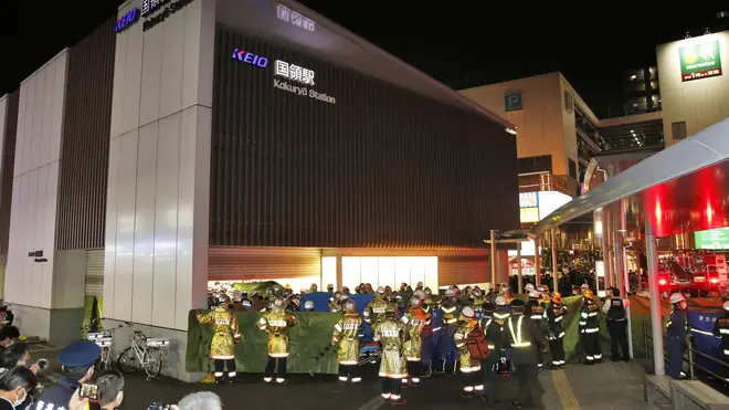 Firefighters gather at Kokuryo Station after the attack