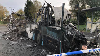 The bus was set alight by masked men on Monday morning